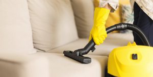 Cleaning sofa with vacuum